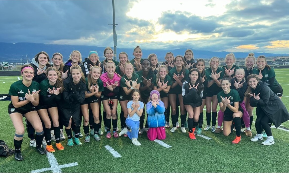 Girls Soccer Team on field at sunset